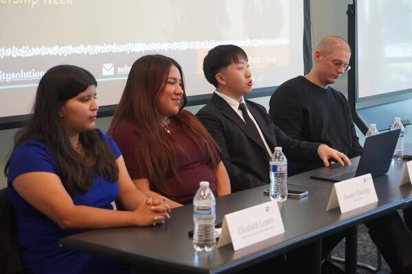Four fellows giving a presentation.