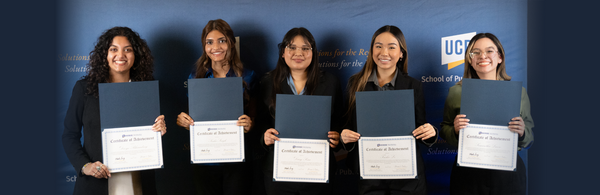 Four female students holding up internship certificates